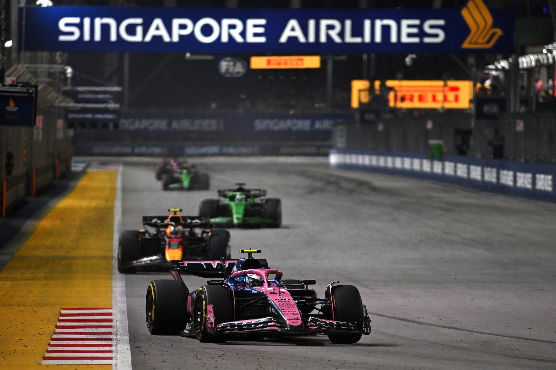 Singapore, Singapore - October 05: Franco Colapinto Of Argentina Driving The (43) Alpine F1 A525 Renault Leads Yuki Tsunoda Of Japan Driving The (22) Oracle Red Bull Racing Rb21 On Track During The F1 Grand Prix Of Singapore At Marina Bay Street Circuit On October 05, 2025 In Singapore, Singapore. (Photo By Sam Bagnall/Sutton Images)